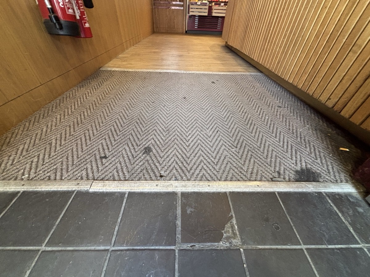 Small bump at foot of doors followed by doormat.