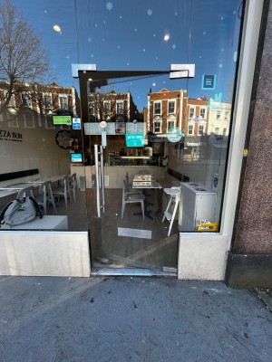 Glass door. Push handle on left to open.