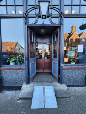 Grey framed glass preceding doors. Push from centre to open.