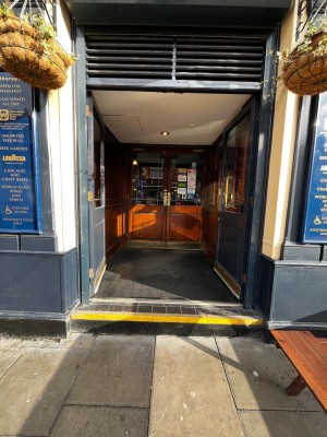 Glass and blue wood doors with metal handles in centre. Push to open.