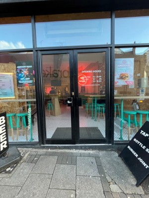 Double glass door outlined in black. Push from centre to open.
