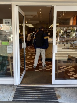 White framed glass double doors. Push from middle to open. Floor before door sloped down to right.