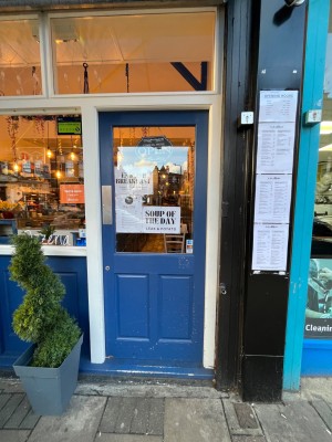 Blue single door outlined in white. Push from left to open.