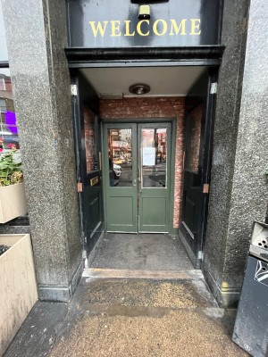 Black wooden double doors. Pull from centre to open.