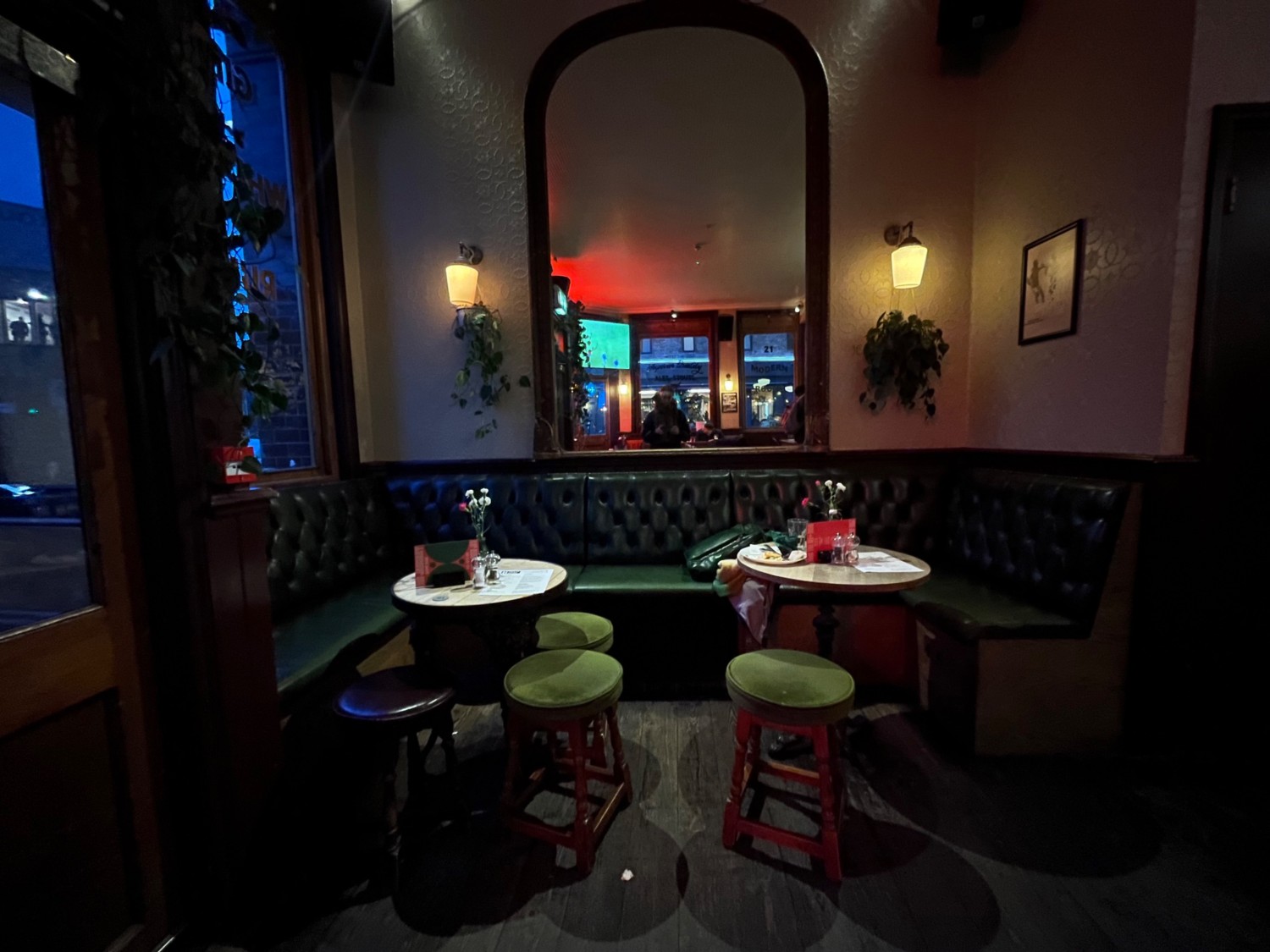 From entrance, facing left. Half-booths and stools along back.
