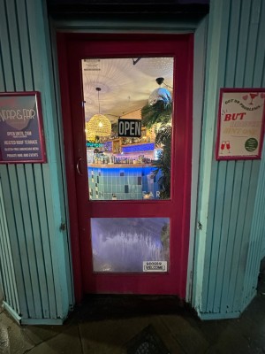 Glass and wood panelled entrance door. Push from left.