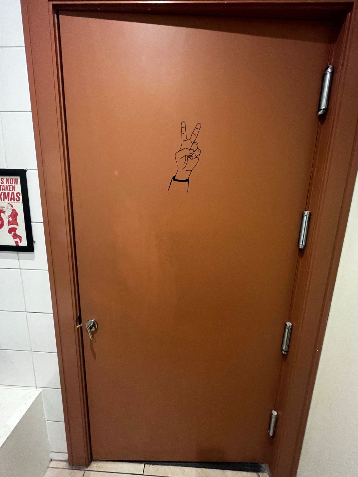 Back of door. Turn lock on left.