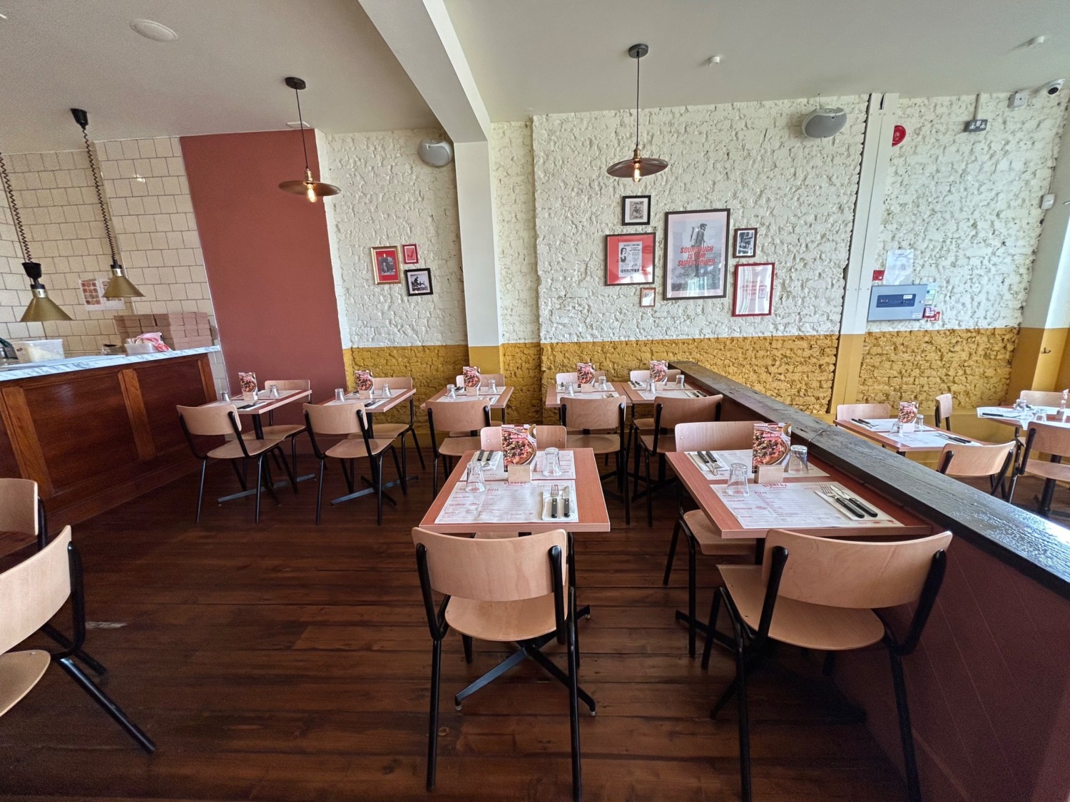 From archway, looking right. Tables and chairs along back wall and directly ahead on right.