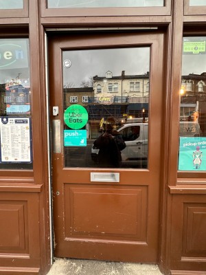 Brown framed glass door. Push from left to open.