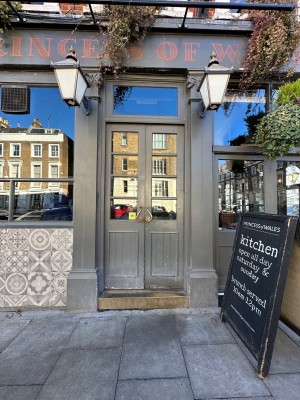 One step up to double wooden glass paneled door. Push from middle to open