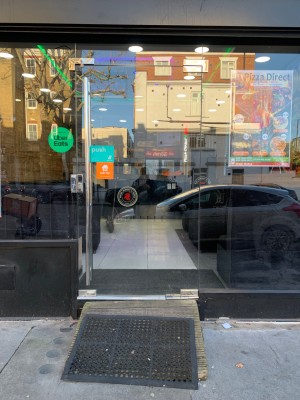 Glass door ahead. Push from silver handle on left to open.