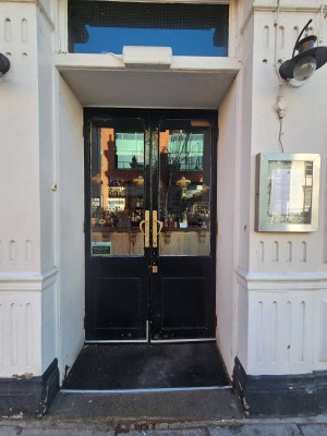 Black doors. Handles in center. Push to open.