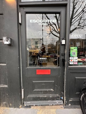 Black and glass panelled door. Pull handle from right to open. White doorbell to right of door.