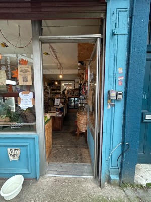Silver metal door with glass panel. Push from left to open.