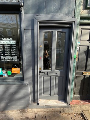 Single grey wooden door with glass panelling. Push from left to open.