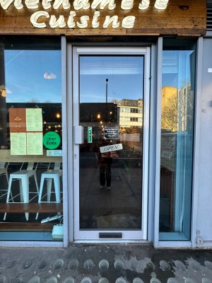 Glass door with silver doorframe. Handle at left. Pull to open.