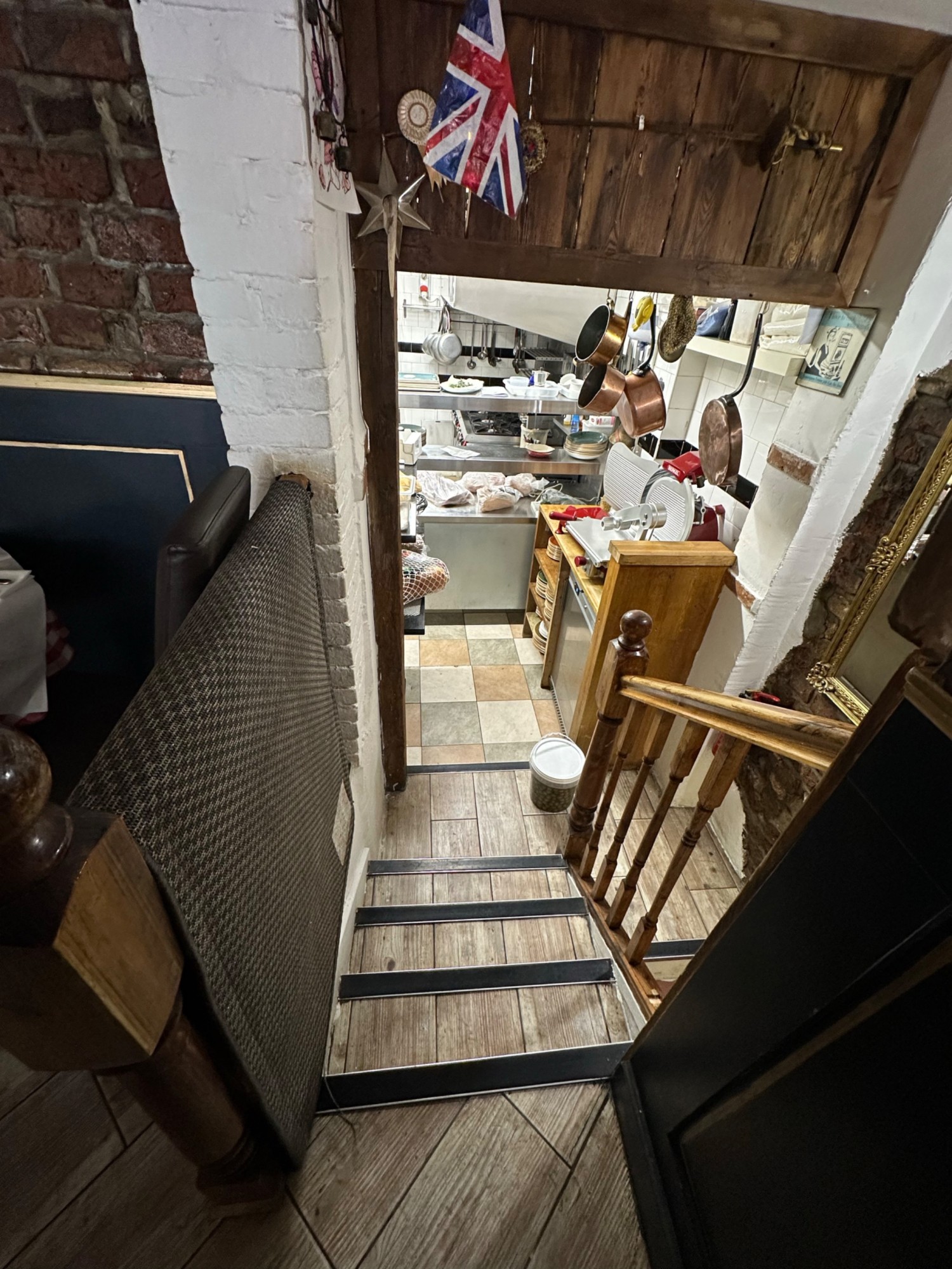 From bannister looking left. First flight of stairs straight ahead. Kitchen ahead past landing. Stairs go back round to right to toilets.