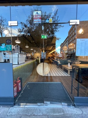 Glass doors. Handles in centre, push to open.