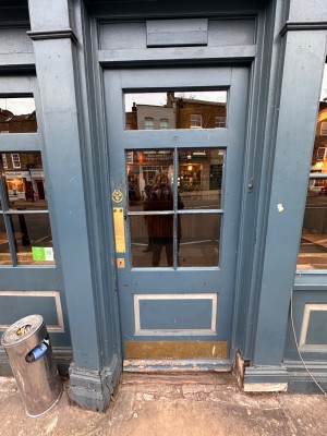 Blue wooden door with glass panels. Push from left to open.