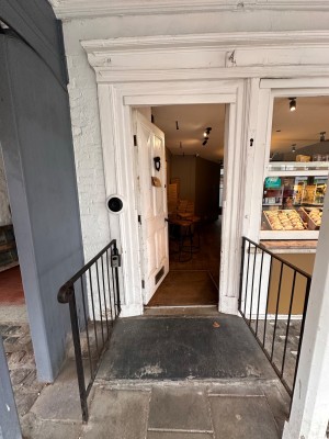 White wooden door. Push from right to open.