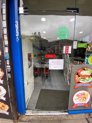 Glass door. Metal handle on right, push to open.