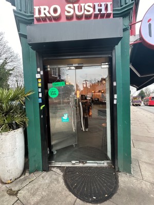 Glass doors with silver handles in middle. Push to open.