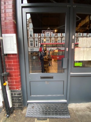 Grey door with glass panel. Push from right to open.