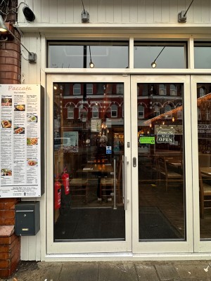 White framed glass door. Push silver handle on right to open. White framed glass windows on right sliding to right.