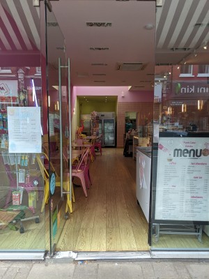 Glass door with silver handle on right. Push to open.