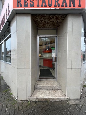 Single glass door with silver metal outline. Push from right to open.