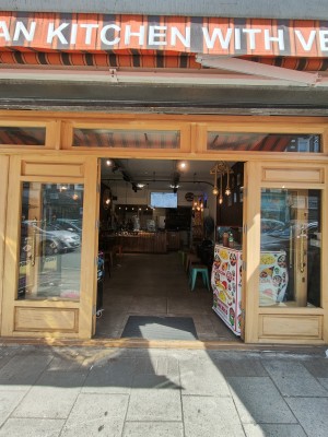 Light brown framed glass doors. Push golden handles in centre to open. Doors fold over to sides.