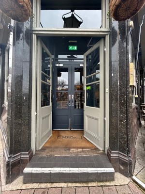 White doors with glass panels and metal handles. Push from centre to open.