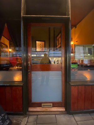 Glass door with wooden frame. Push from left to open.