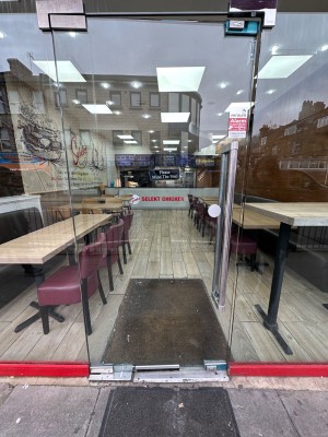 Glass door. Push silver handle from right to open.