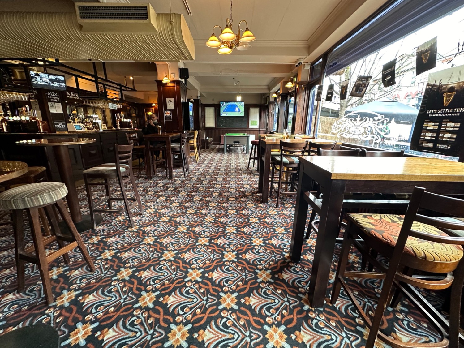 From entrance, facing right. High tables and stools on left and right. Bar to back left.