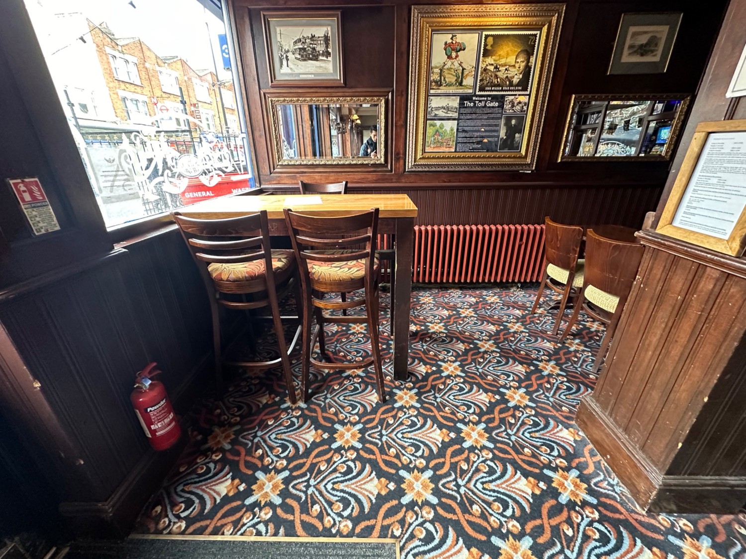 From entrance facing left. High table and stools ahead. Column on right.