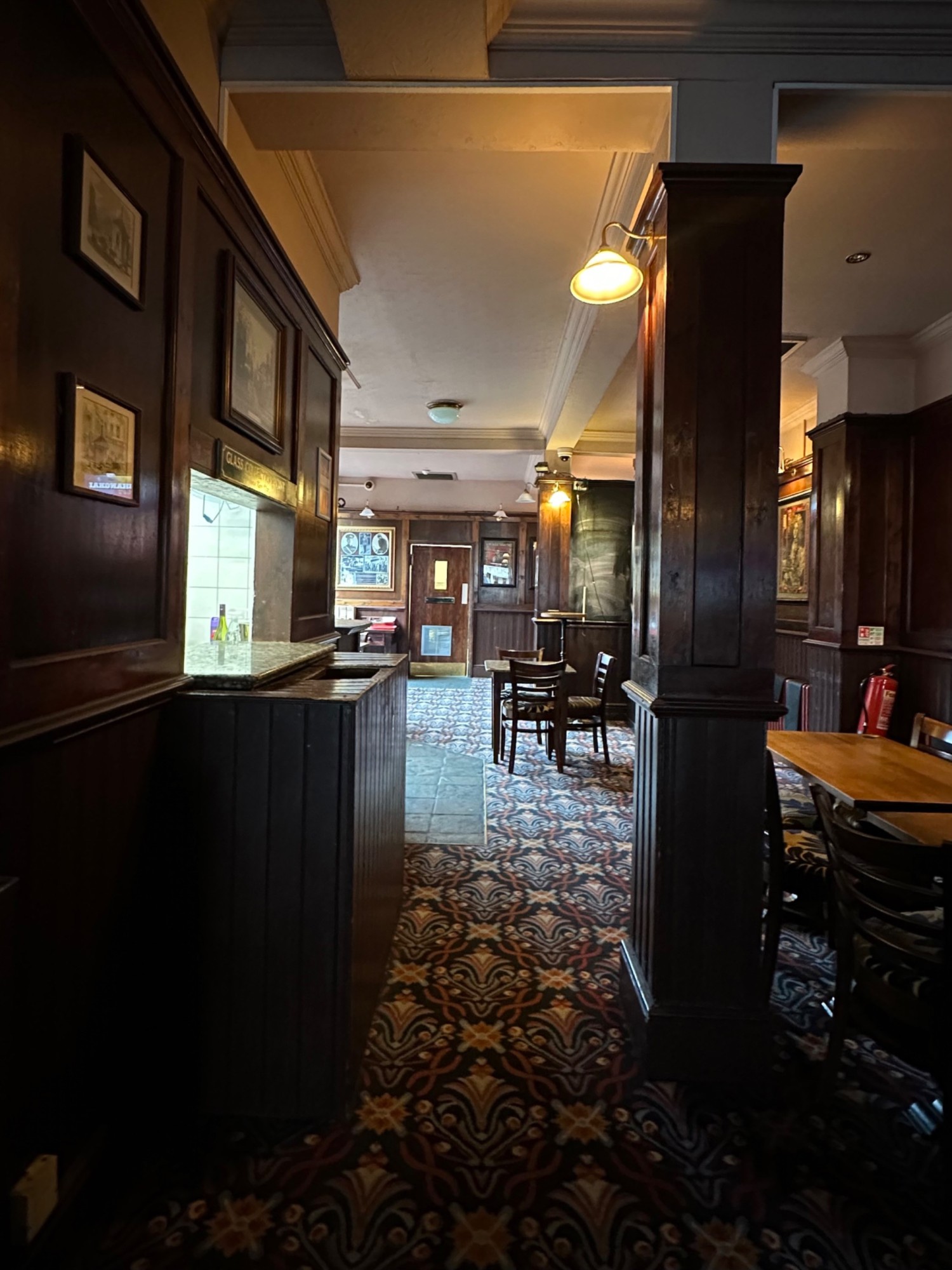 From end of tables facing straight. Second column on right. Tables and chairs on its right.