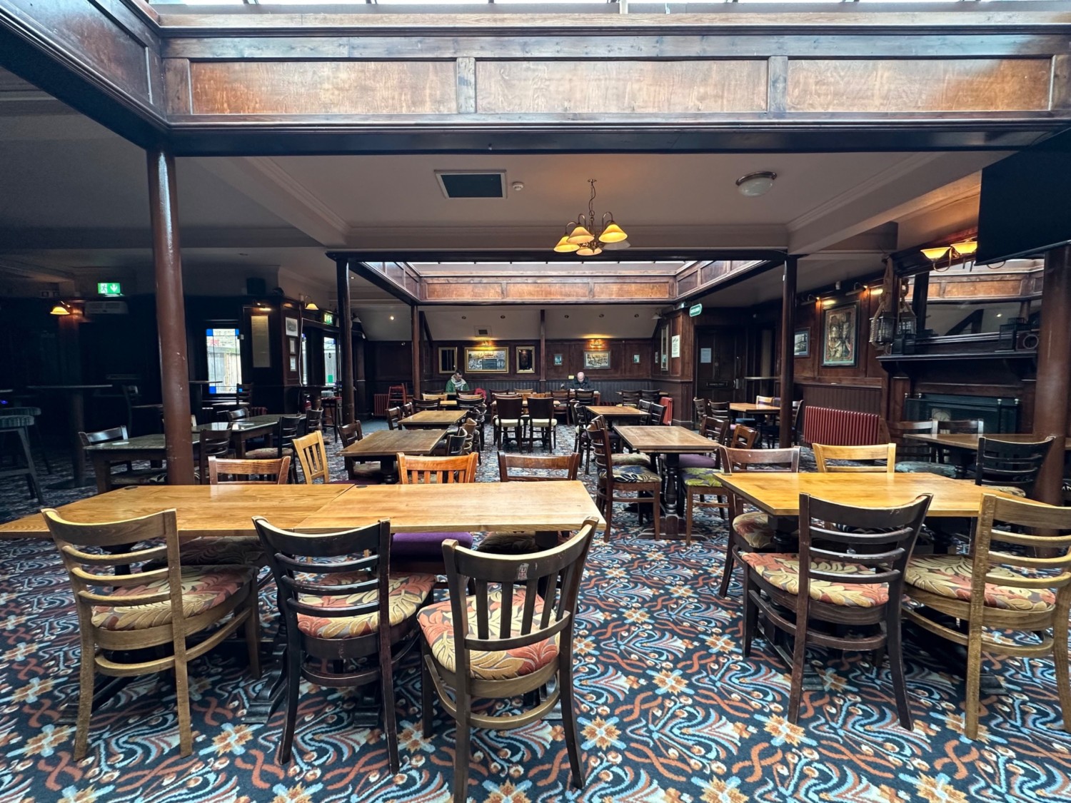 From the end of tables facing straight. Tables and chairs ahead.