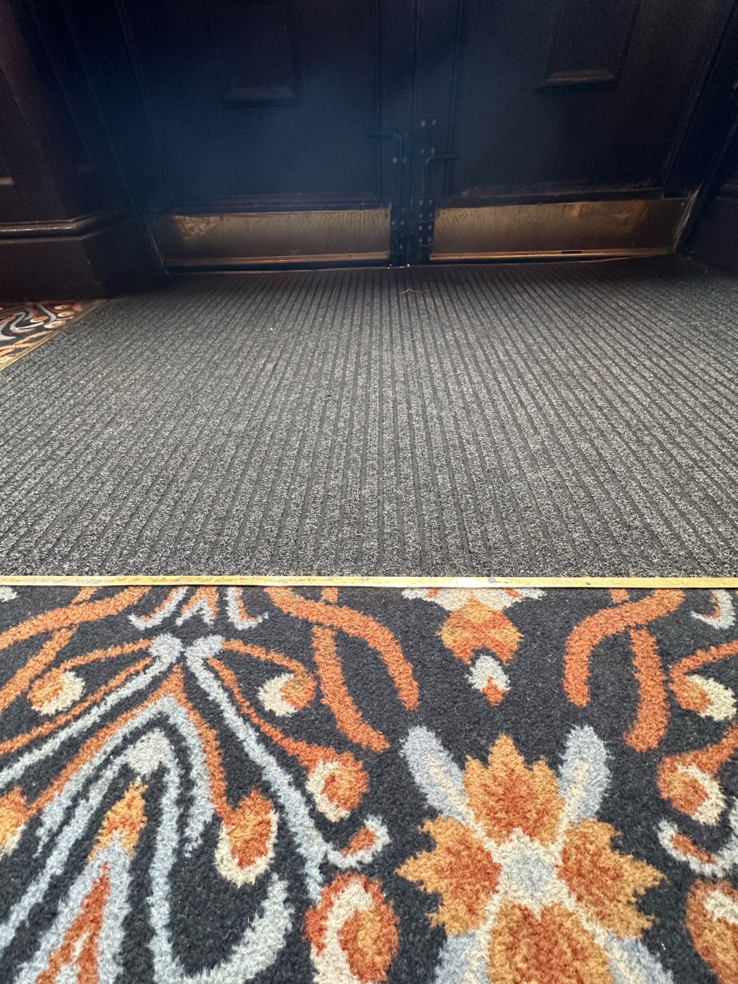 Small bump and doormat before doors.
