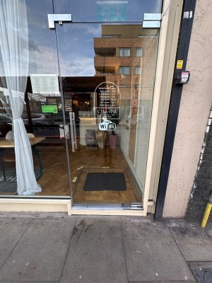 Glass door ahead. Push silver handle on left to open.