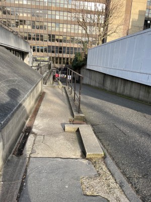Built in ramp with handrail to right. Obstruction along front right.
