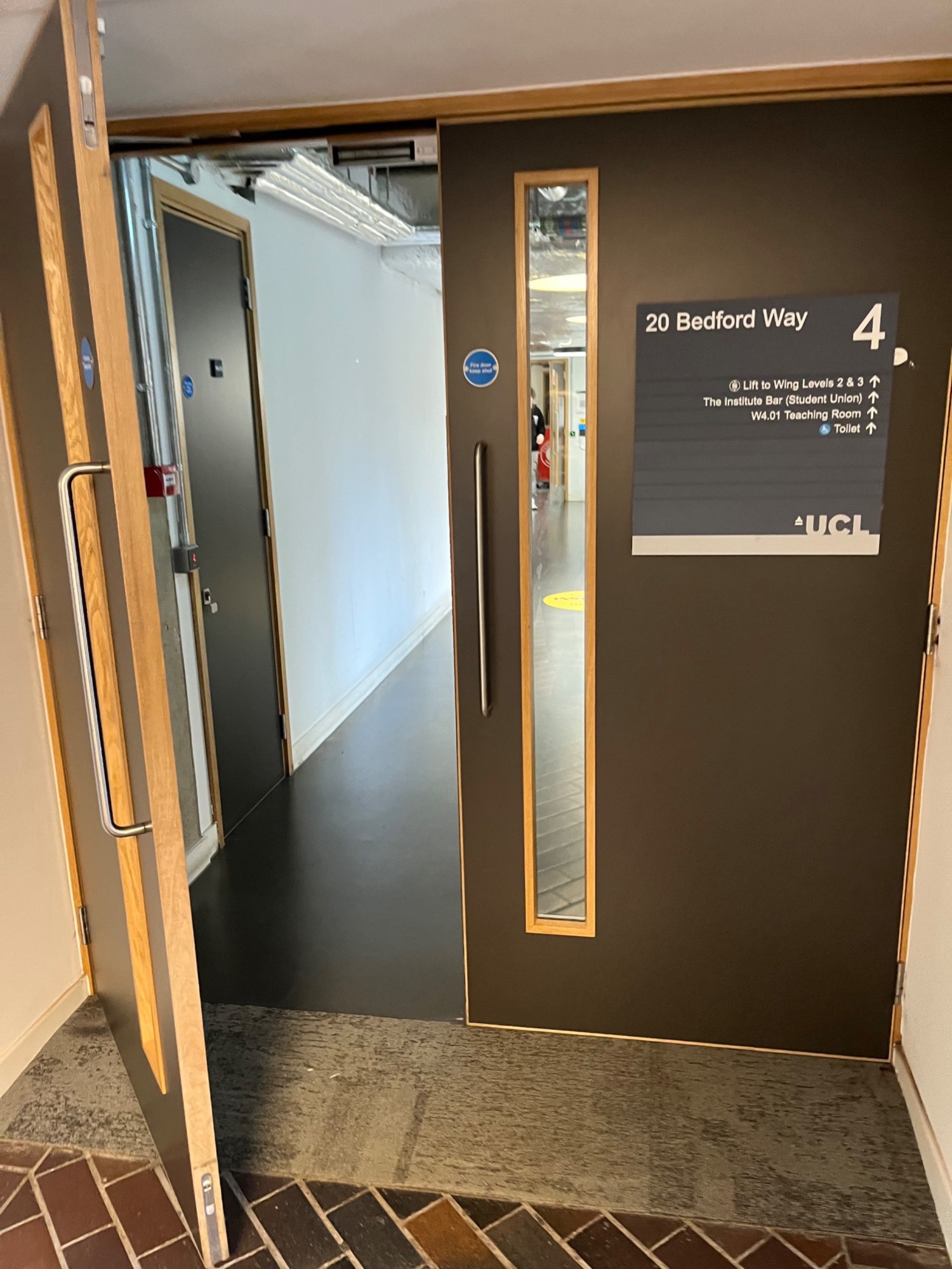 Brown framed black doors. Pull from centre via long metal handles to open.