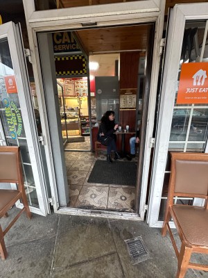Glass doors with white frames. Push from centre to open.