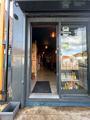 Glass panelled entrance door with black frame. Slide open from left.