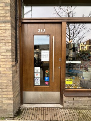 Wooden glass paneled door. Push silver handle from right to open.