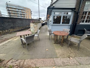 Path ahead in between front area seating from street to front of pub.