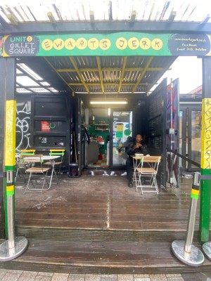 From street, facing venue. Two steps up to doorway at back.