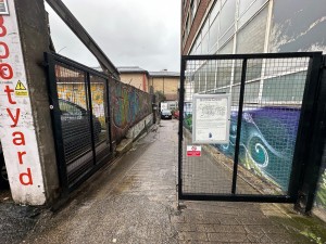 Double black gated door ahead. Push at center to open.