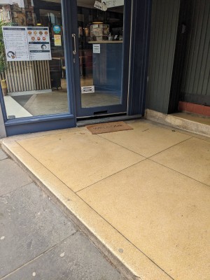 One large step 10cm before the door, another small one by the door