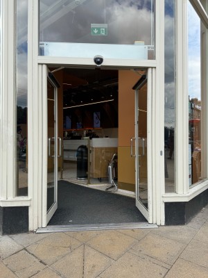 Entrance double doors open inwards from the centre. Immediately after is a small carpeted incline ramp.